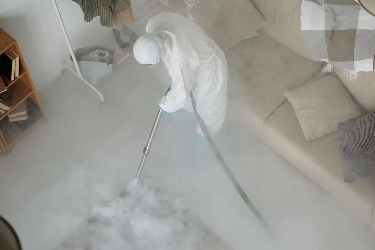 Biohazard cleanup technician in protective equipment, Worthington, MN